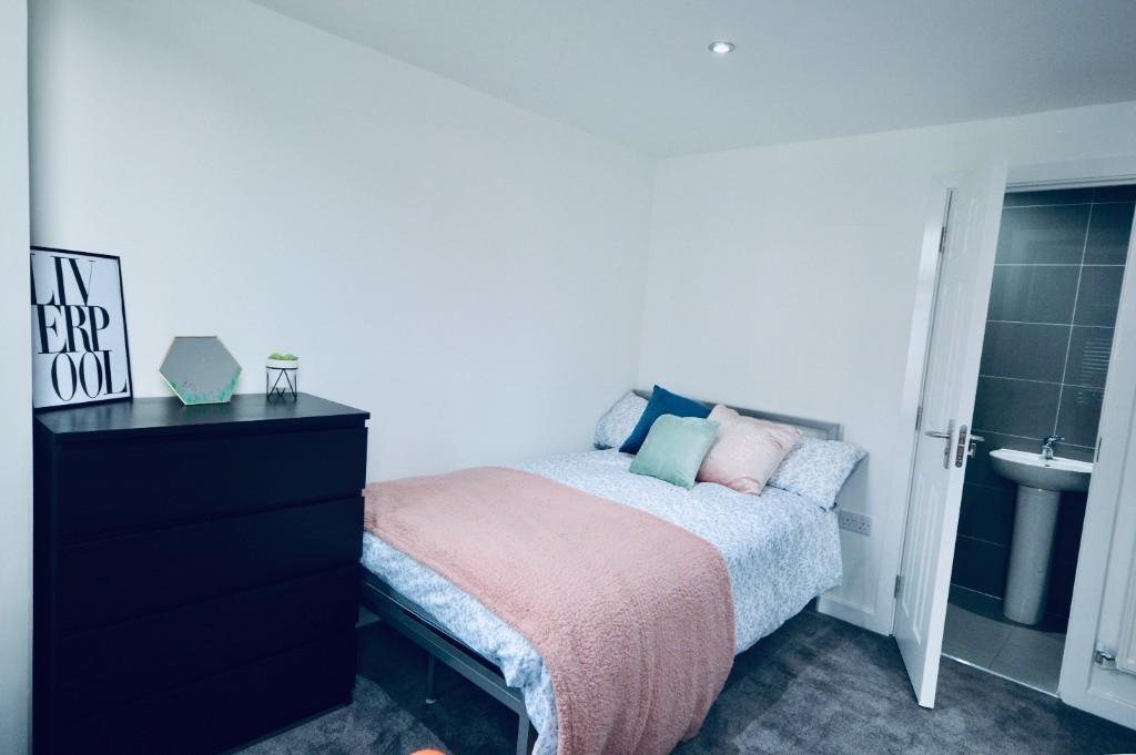 A cozy and well-maintained bedroom featuring a ...