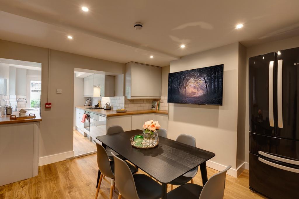 A modern open-plan kitchen and dining area with...