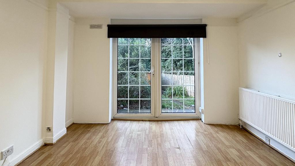 Bright, neutral living room with large glazed p...