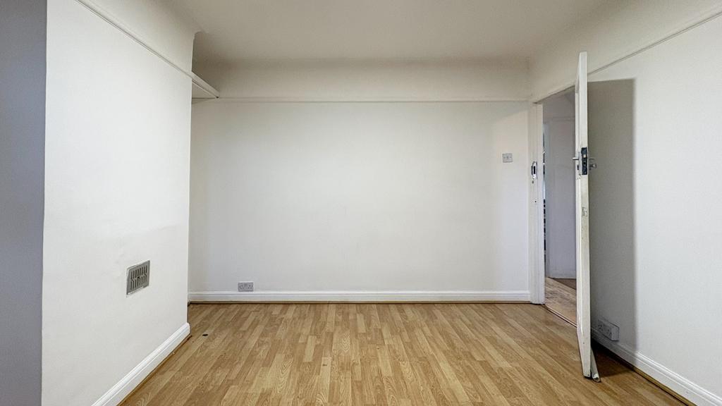 Bright, neutral living space with light wood fl...