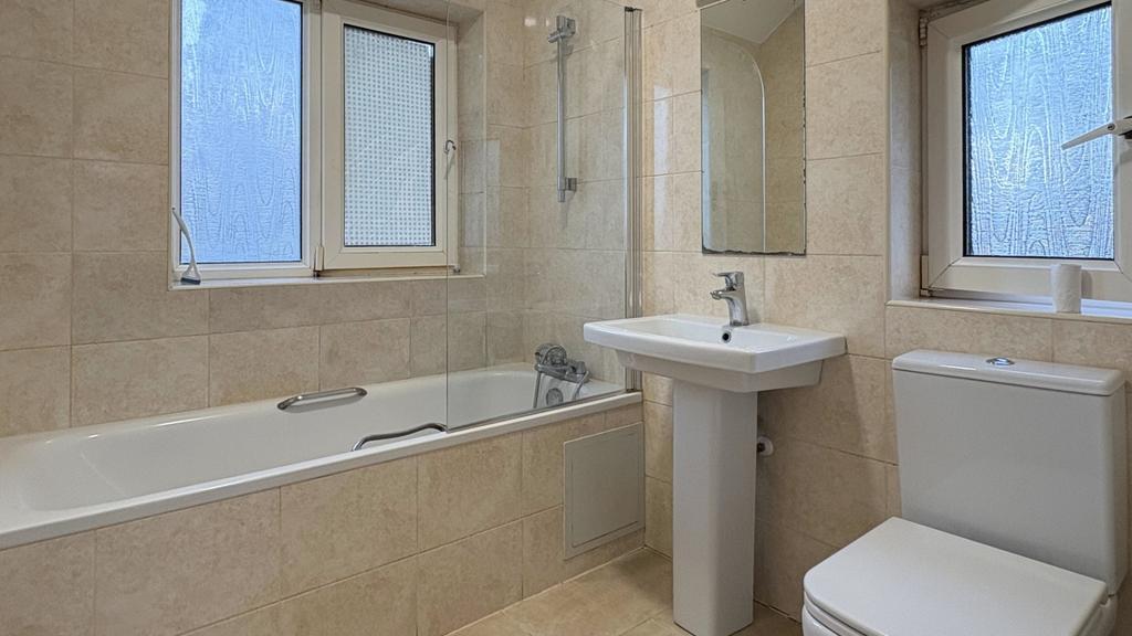 Bright, modern bathroom with a full-length bath...