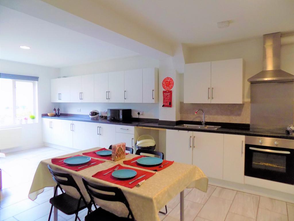 Bright and spacious kitchen with modern white c...