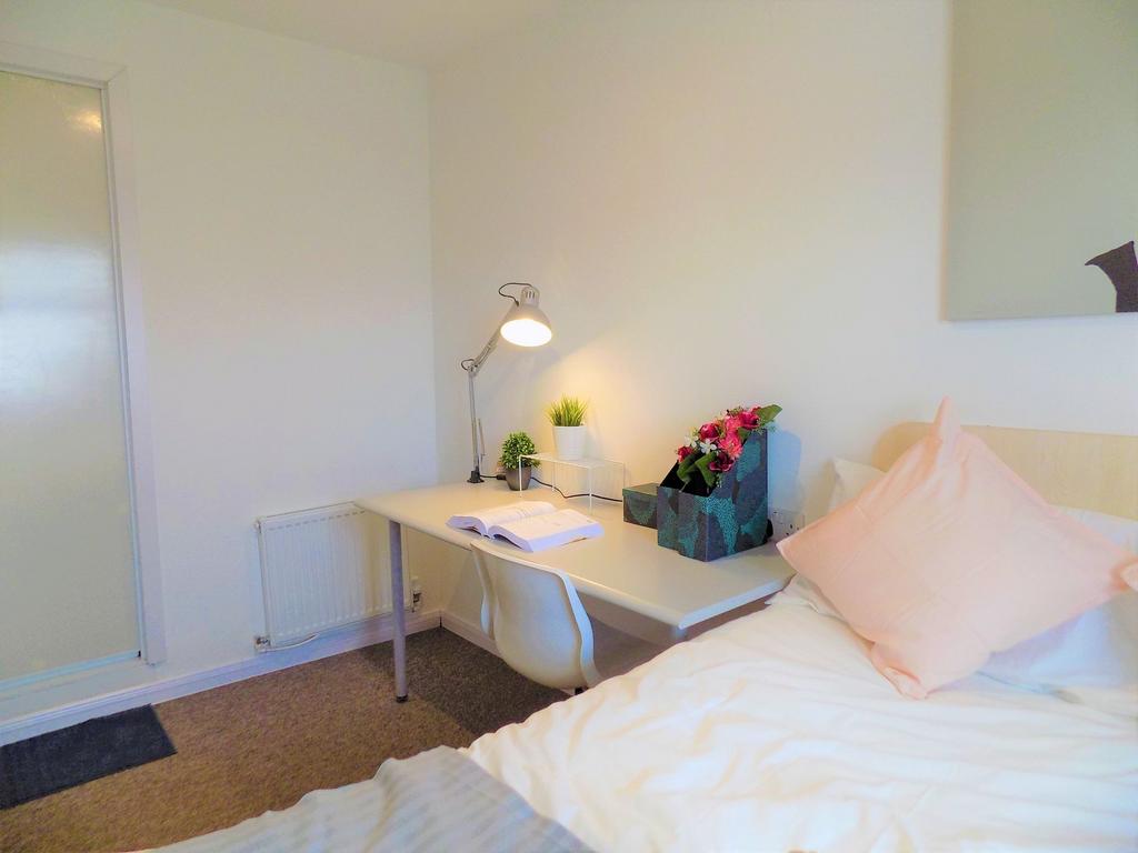 A neat and cozy single bedroom featuring a comp...