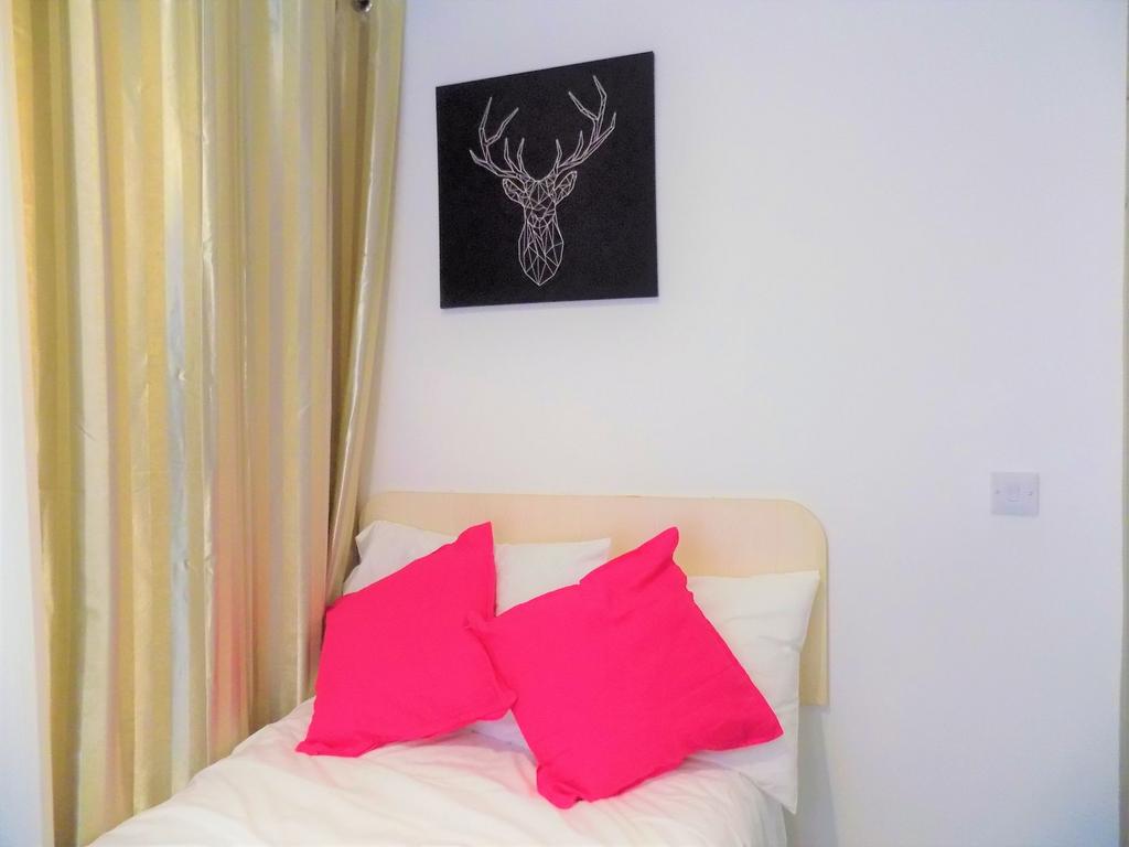 A cozy single bedroom featuring a neatly made b...