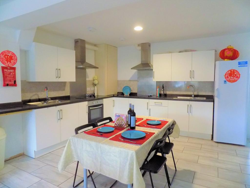 Bright and modern kitchen featuring white cabin...