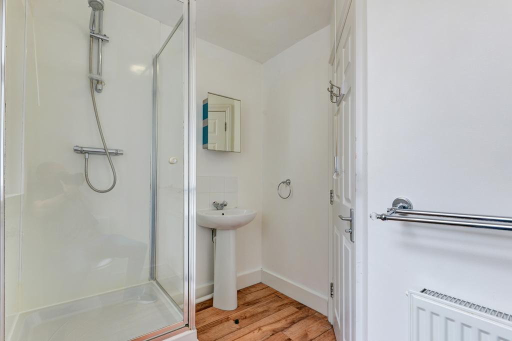 Bright, modern bathroom featuring a walk-in sho...