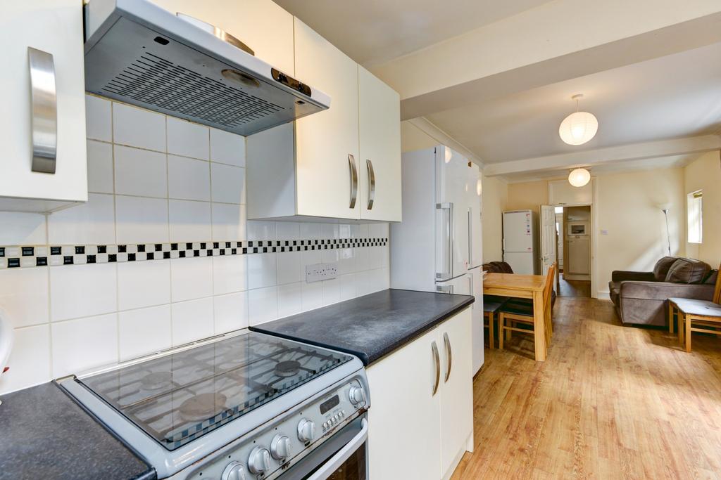 Bright, modern galley-style kitchen with integr...