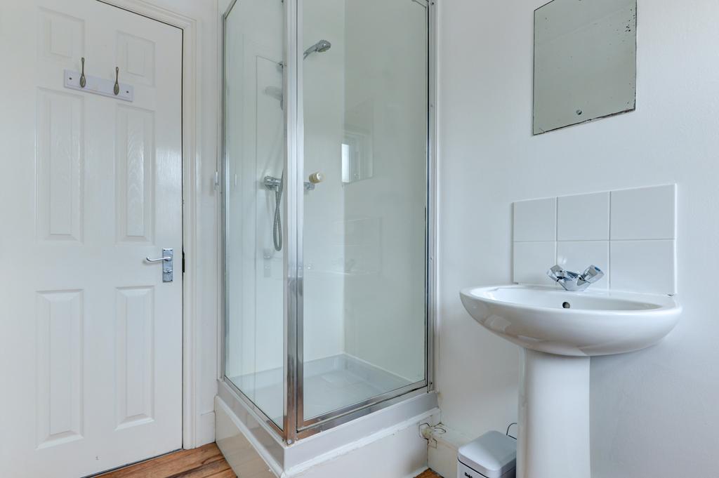 Bright, modern bathroom with a glass-enclosed s...