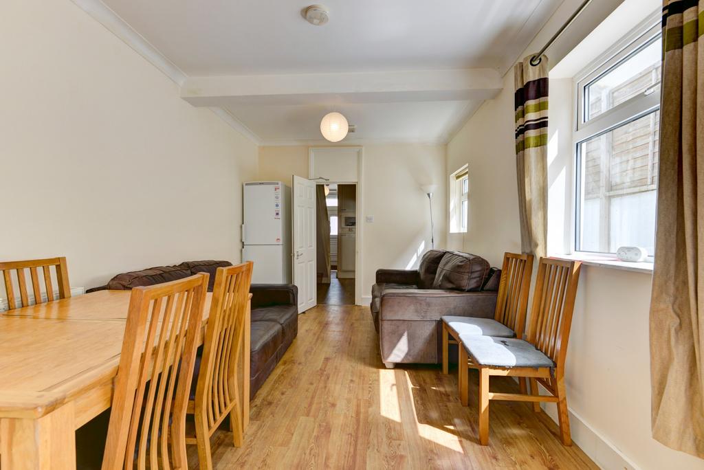 Bright, well-kept living/dining space with wood...