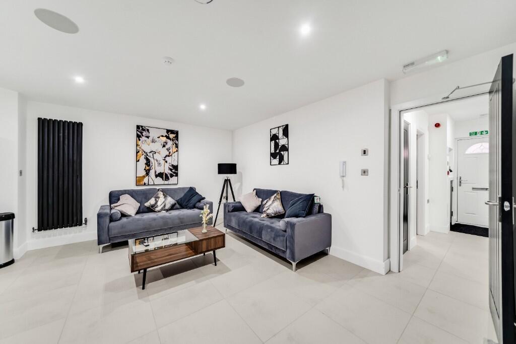 A bright and modern living room featuring styli...