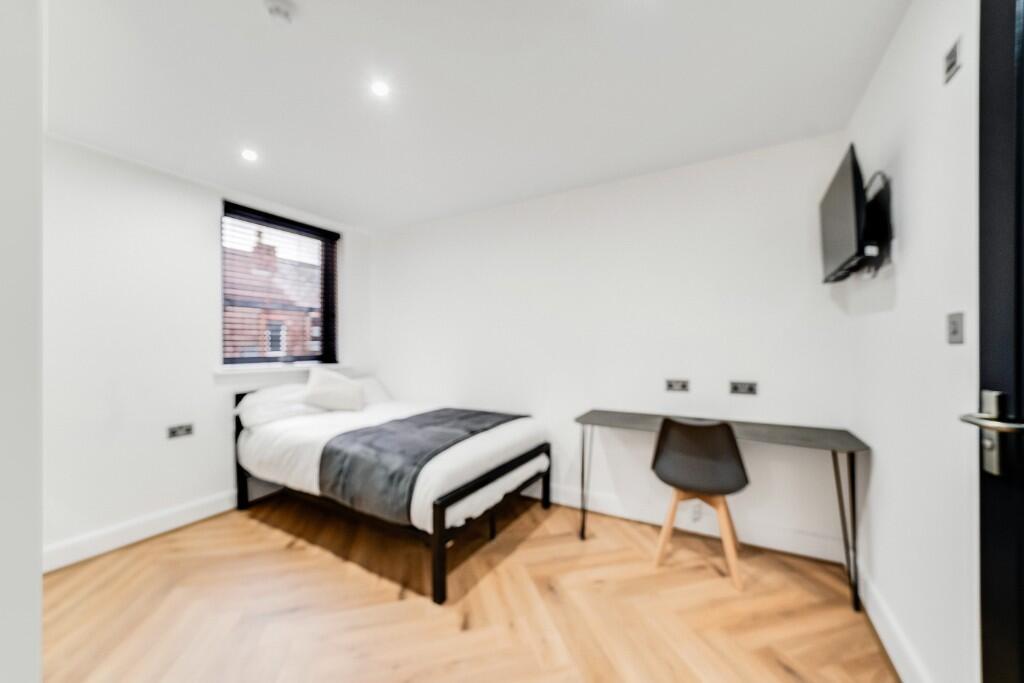A bright and modern double bedroom featuring a ...