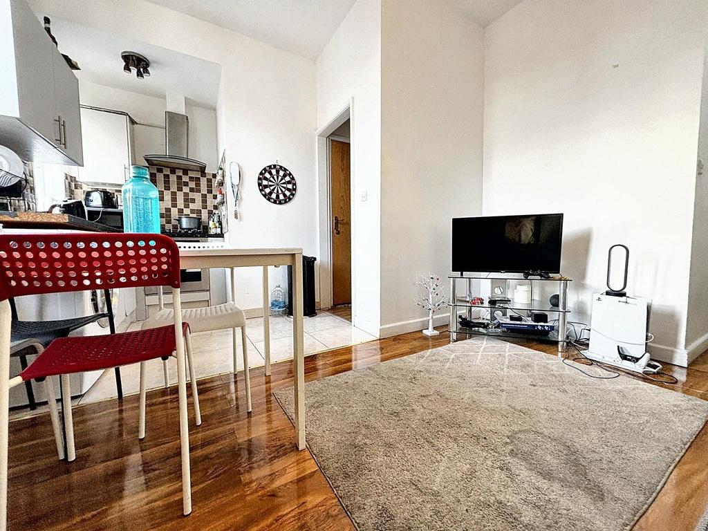 Bright open-plan living area with wood floors, ...