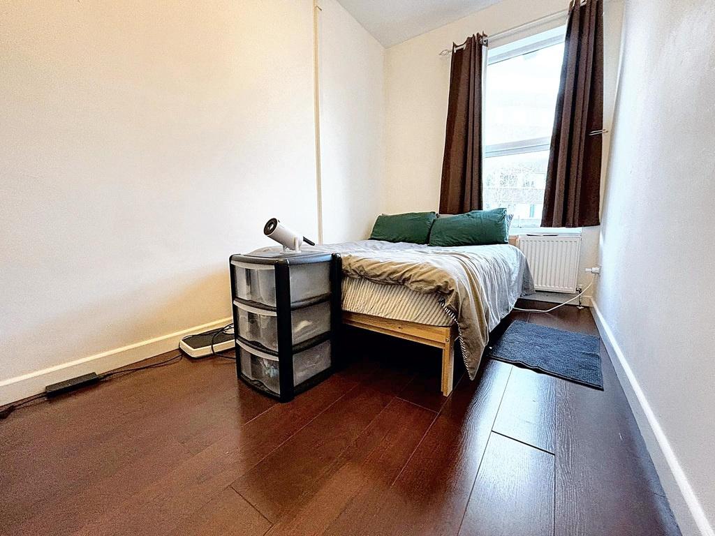 Neat single bedroom with a single bed, wooden f...