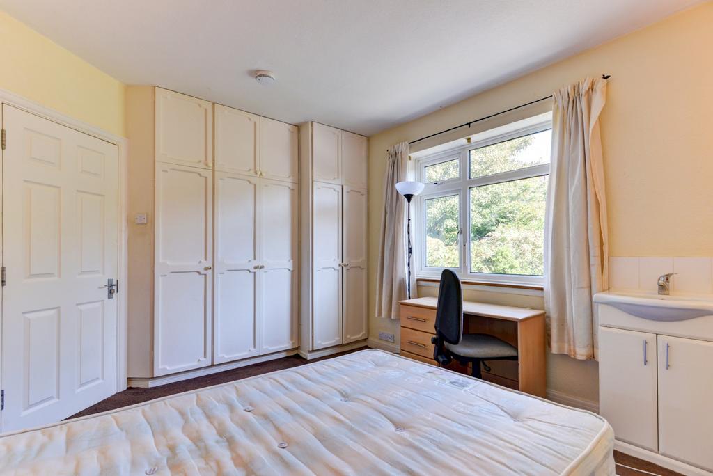 A bright and welcoming bedroom with ample natur...