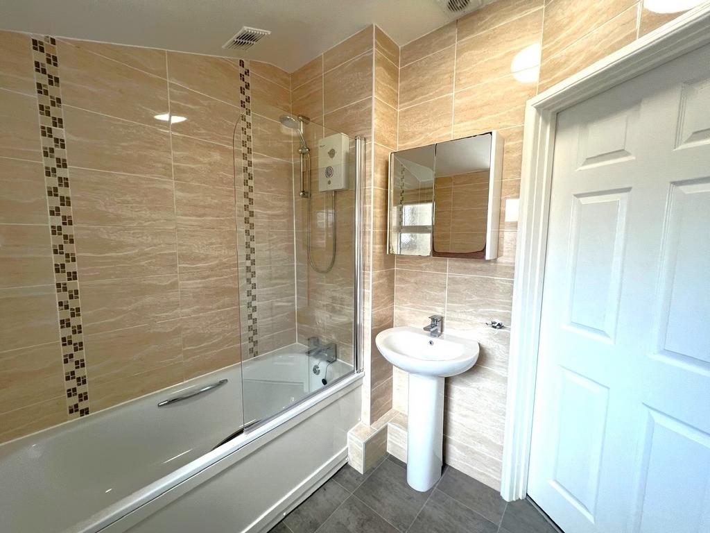 Bright, modern bathroom with a full bath and ov...