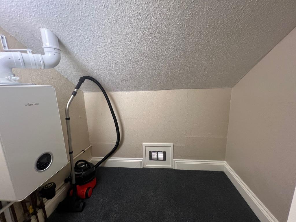 Compact utility/storage cupboard with fitted bo...