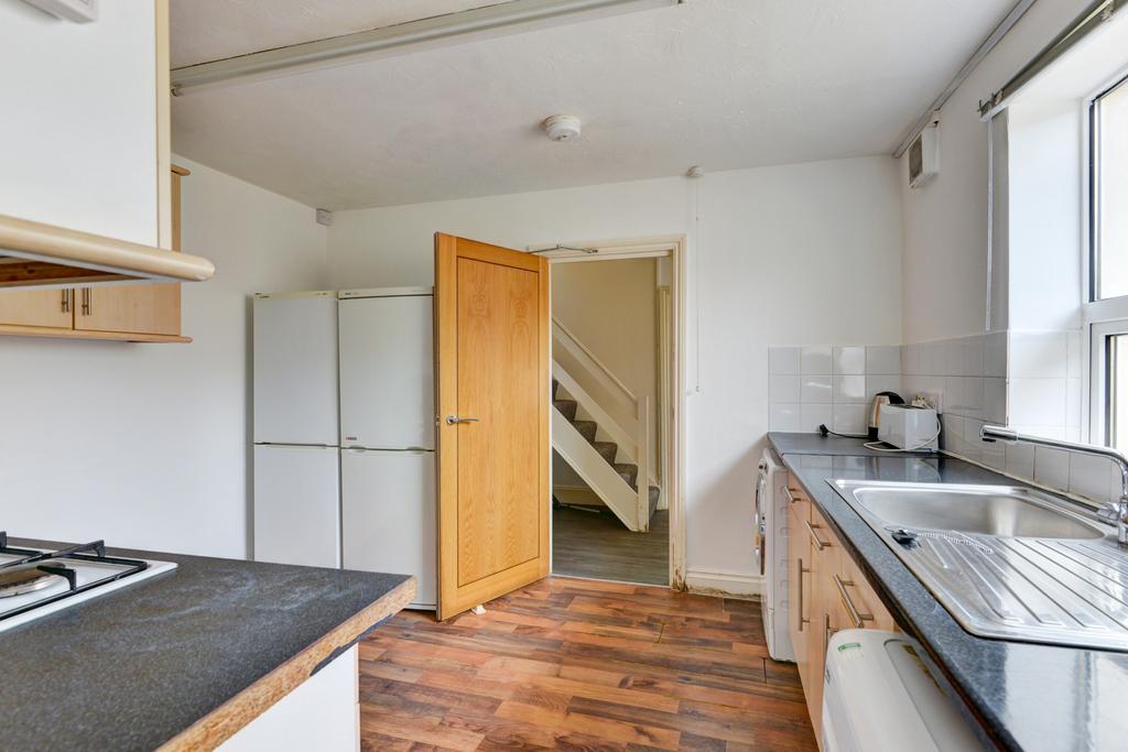 Bright kitchen with a long countertop, large wi...
