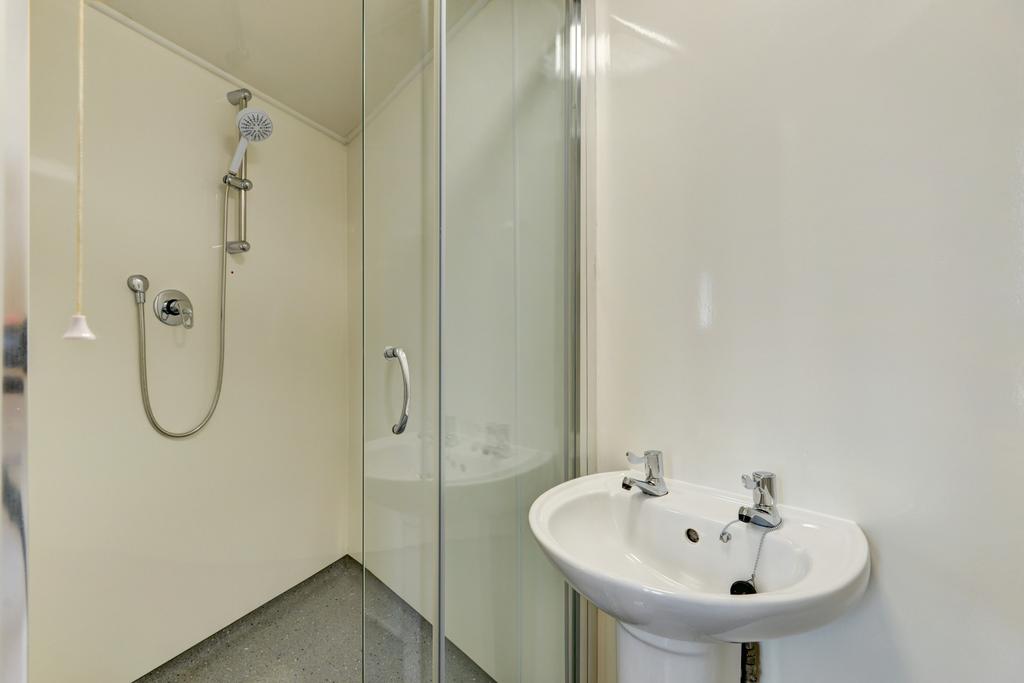 Bright, modern bathroom with a walk-in shower a...
