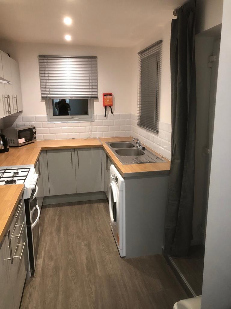 A modern, well-maintained kitchen featuring woo...