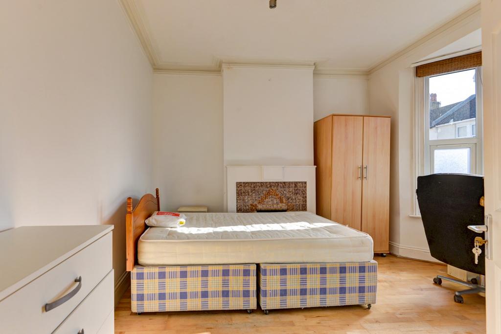 A bright and tidy bedroom featuring a double be...