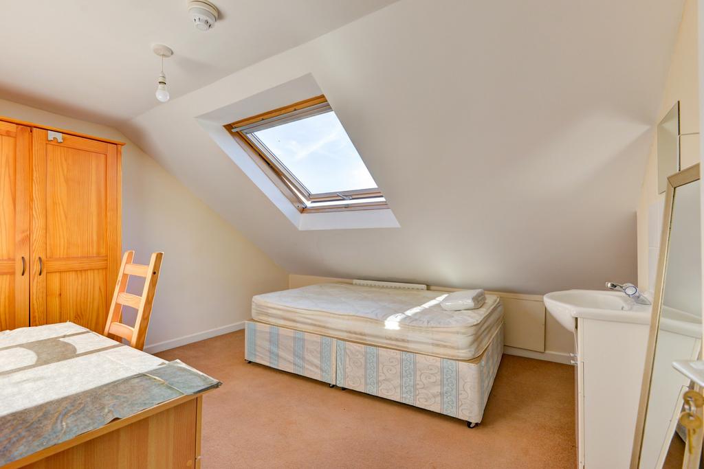 Bright and cozy bedroom with a skylight that br...