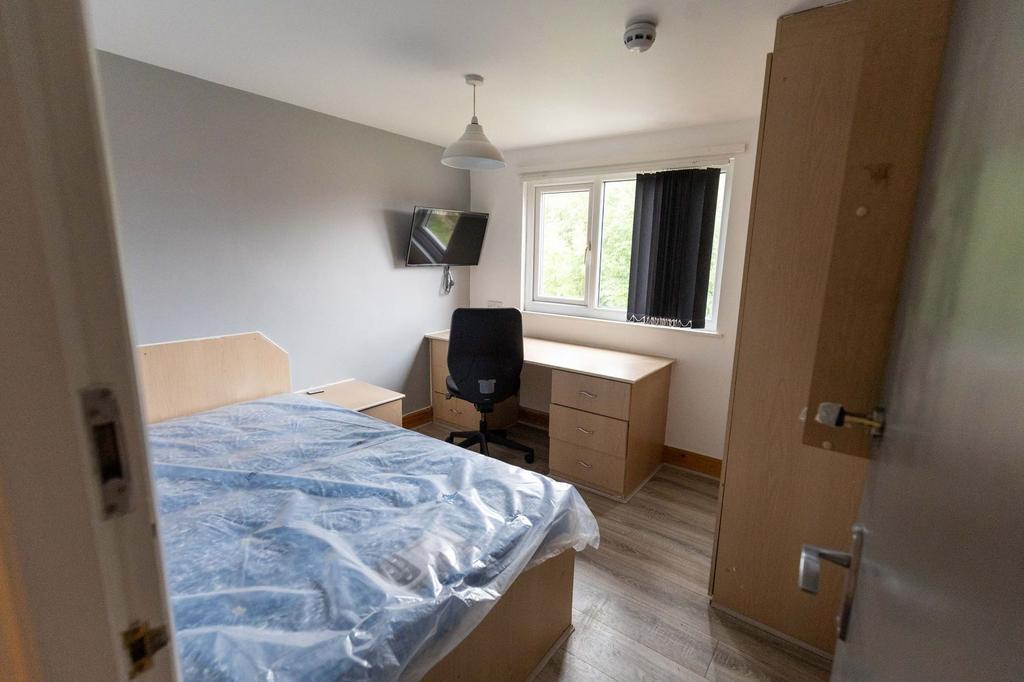 Bright and welcoming bedroom with a large windo...