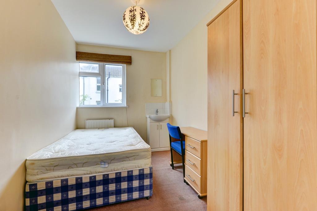 Neat single bedroom with a comfortable bed, bui...