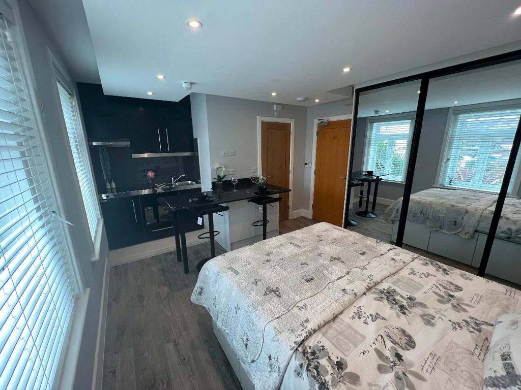 Bright, modern bedroom with a double bed, large...