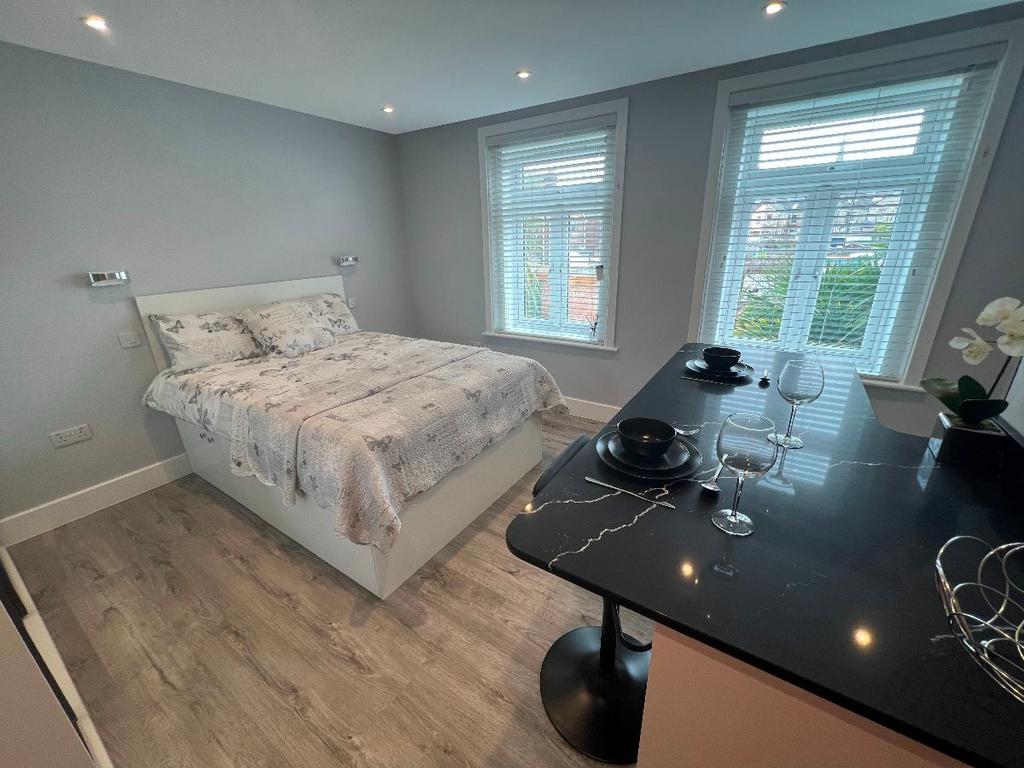 Bright, modern double bedroom with neutral deco...