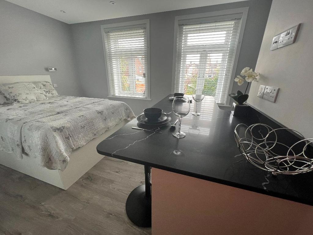 Bright, modern double bedroom with a comfortabl...