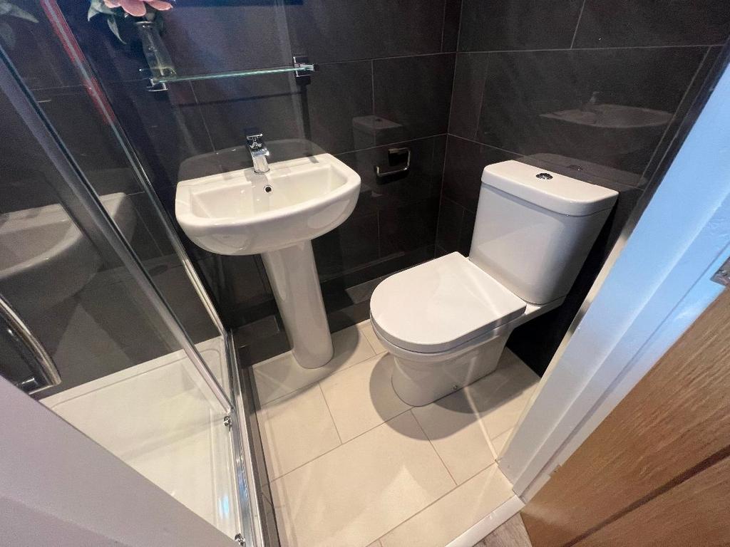 Contemporary tiled bathroom with a corner showe...