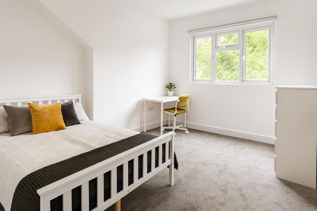 Bright, freshly decorated bedroom with a comfor...