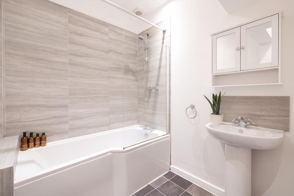 A clean and modern bathroom featuring a spaciou...