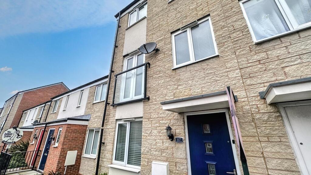 Street-facing view of a modern terraced townhou...