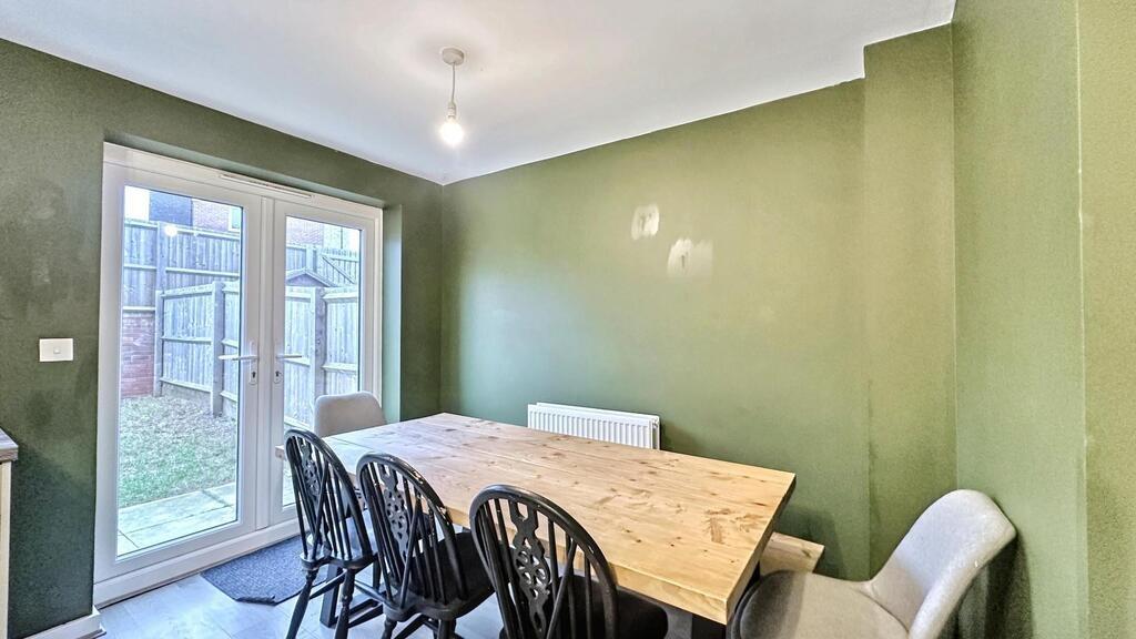 Bright dining area with a large wooden table an...