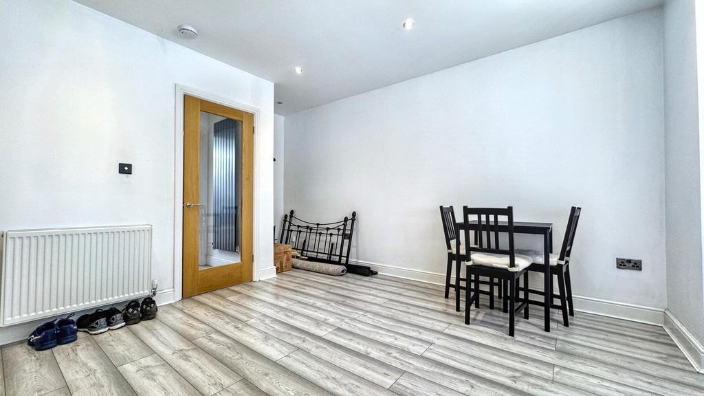 Bright, modern living area with pale wood-effec...