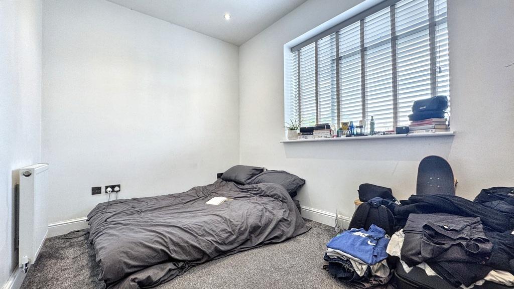 Compact, bright bedroom with a large window and...