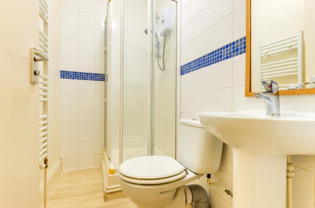 A clean and functional bathroom featuring a sho...