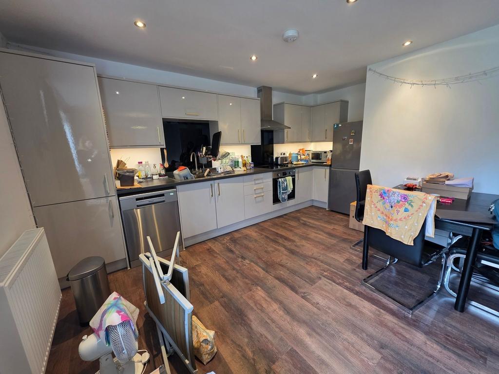 Bright modern kitchen with glossy fitted cabine...