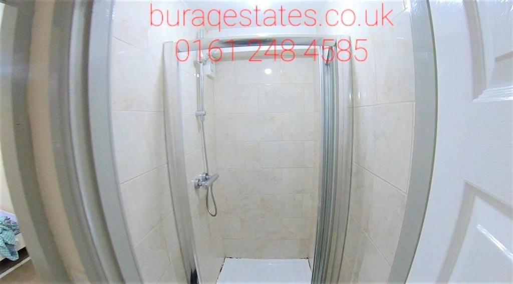 Modern tiled shower enclosure with a clear glas...