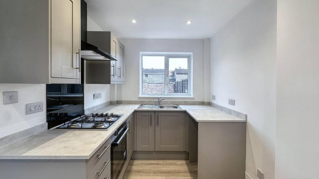 Bright modern galley kitchen with neutral cabin...