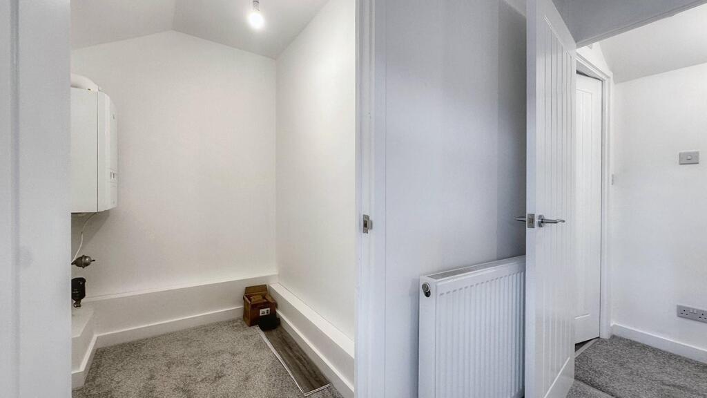 Bright, freshly painted hallway with neutral ca...