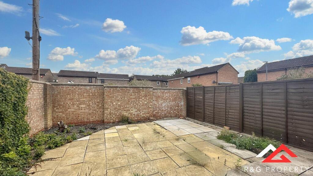 Private paved rear garden with a spacious patio...