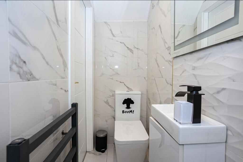 Contemporary small bathroom with sleek marble-e...