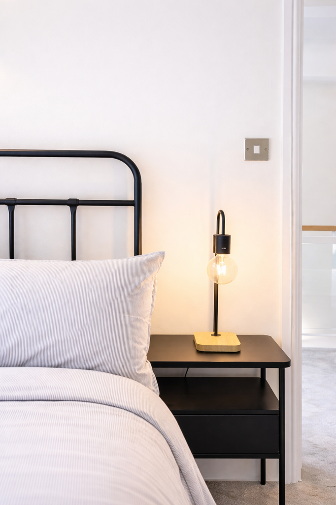 Modern bedside with stylish lamp