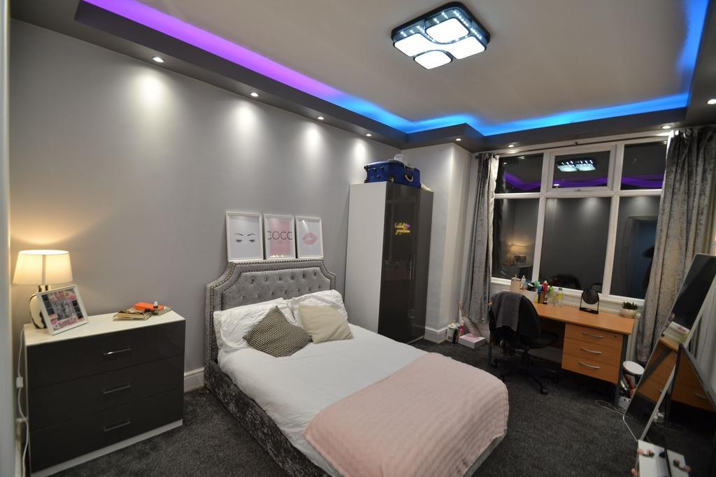 Stylish double bedroom with a plush upholstered...