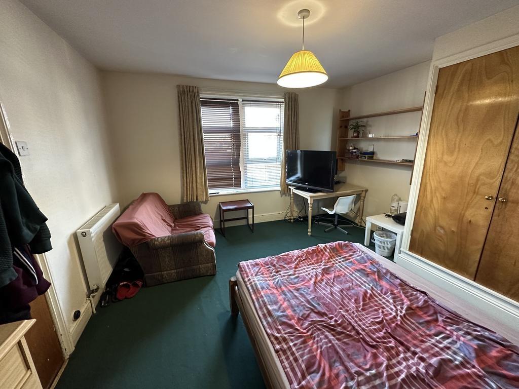 Bright double bedroom with large window, fitted...