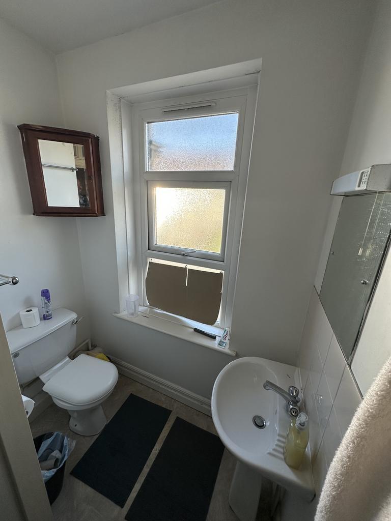 Bright, tidy bathroom with frosted window, pede...