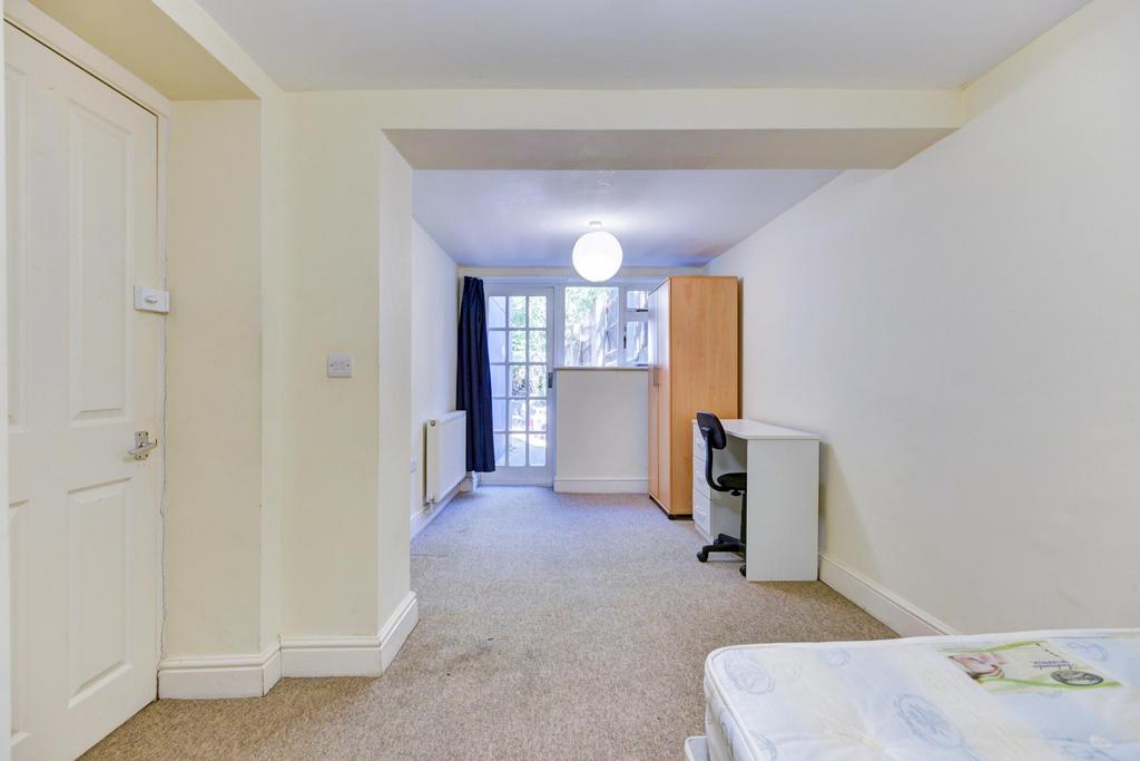 Bright, open bedroom with neutral decor, fitted...