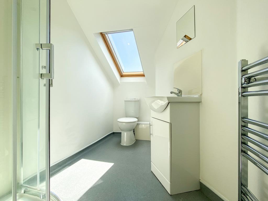 Bright, modern bathroom with a skylight, walk-i...